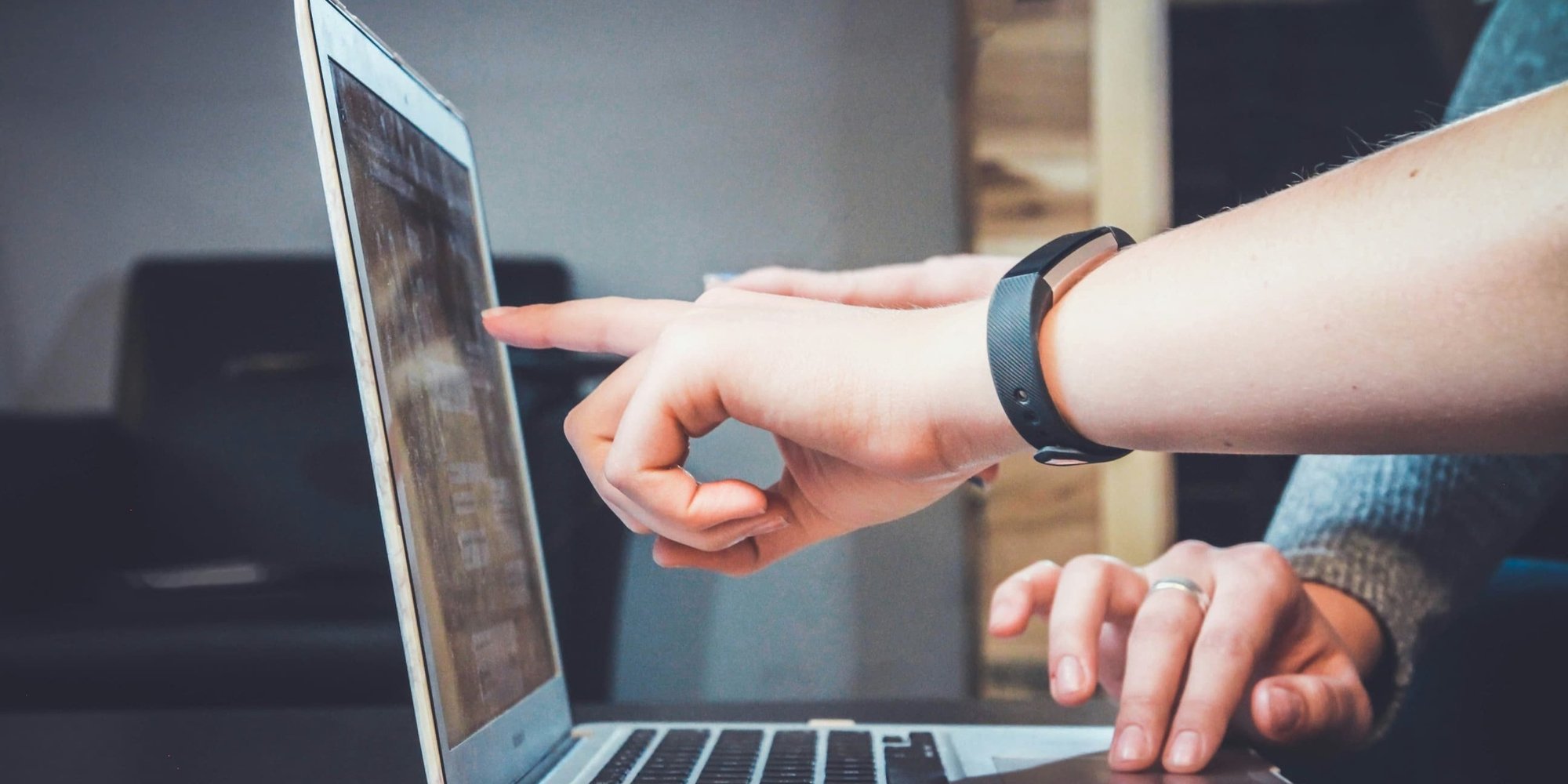 person pointing at computer-1
