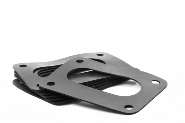 a pile of flexible die-cut parts fabricated out of rubber