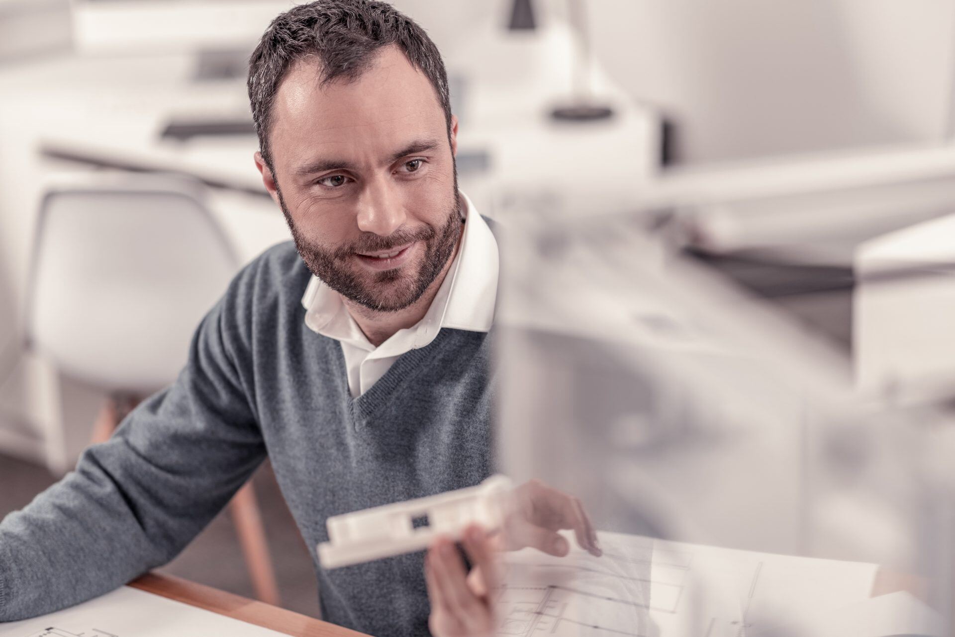 a product development engineer reviewing a plastic fabricated part