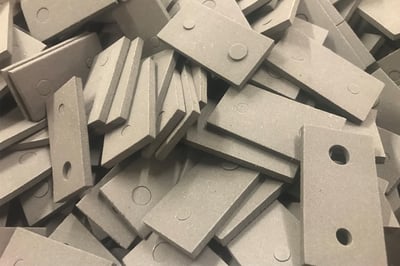 a pile of die-cut parts