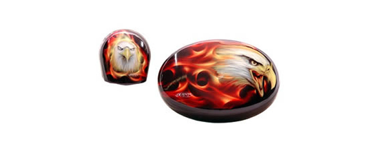 a plastic fabricated part. a design has been applied of a bald eagle against flames.