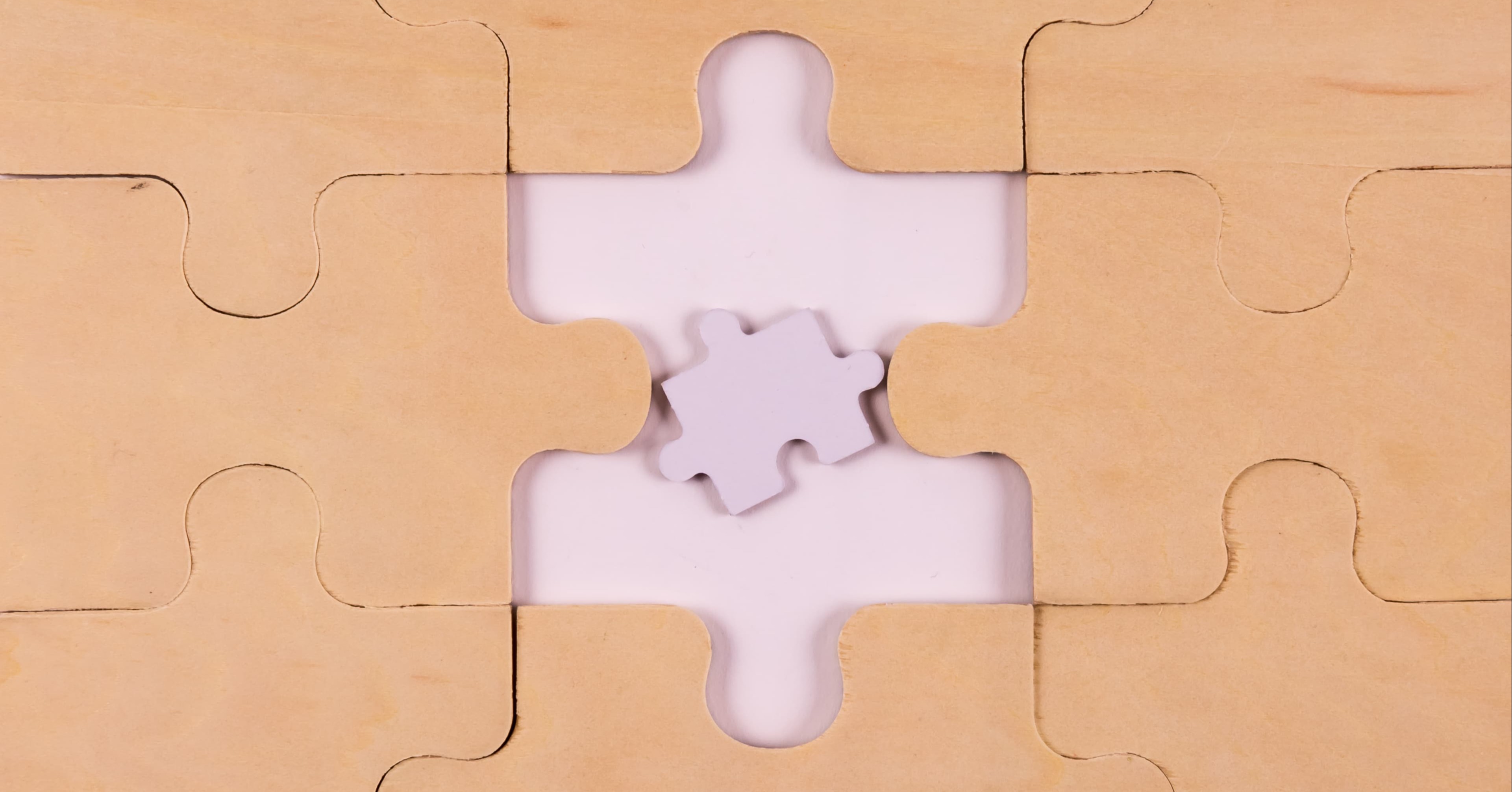 A puzzle made of wood with a too small piece in the middle that does not fit in.
