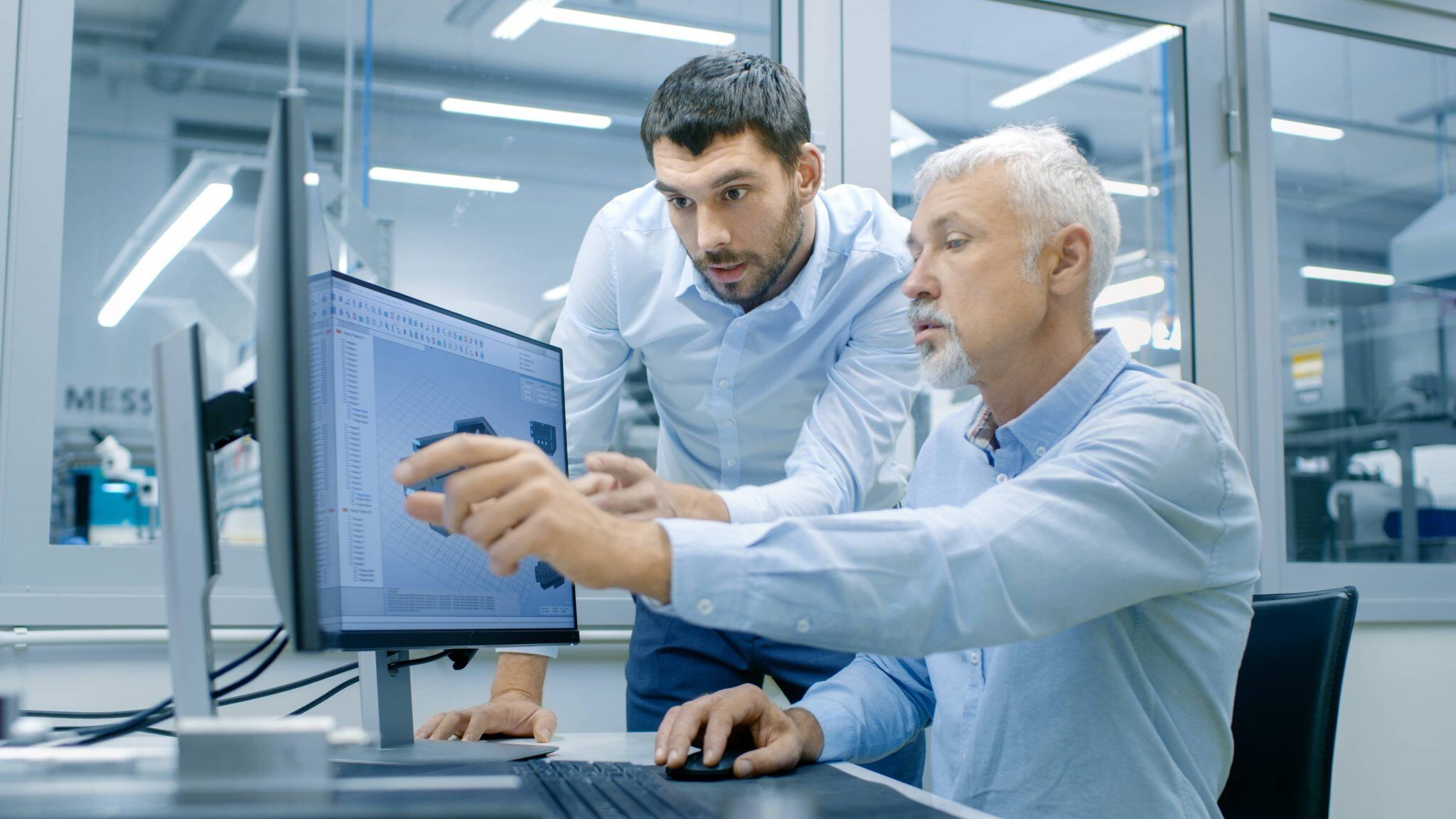 two people pointing at a computer